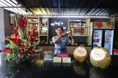 a man standing in a store taking a picture of a table at Jay's Villa Umalas in Canggu