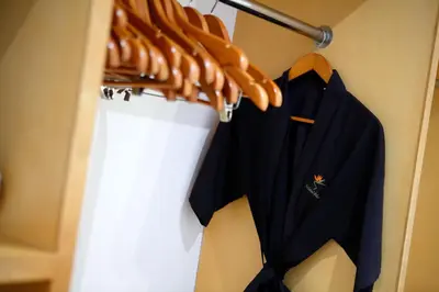 a black shirt hanging on a hanger in a closet at Bali Island Villas and Spa Seminyak in Seminyak