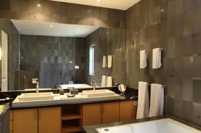 a bathroom with two sinks and a large mirror at Bali Island Villas and Spa Seminyak in Seminyak