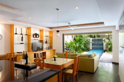 a living room with a couch and a table at Bali Island Villas and Spa Seminyak in Seminyak