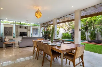 a dining room with a table and chairs at Dream villa Seminyak in Seminyak