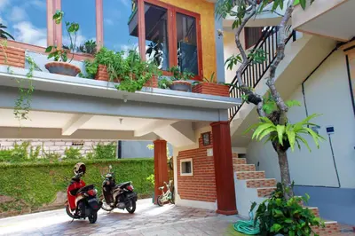 two motorcycles parked in front of a house at CR Tris Rooms Seminyak in Seminyak