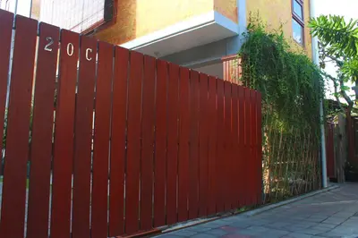 a red fence in front of a building at CR Tris Rooms Seminyak in Seminyak