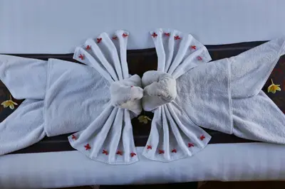 a bed with white sheets and stuffed animals on it at The Sanyas Suite Bali in Seminyak
