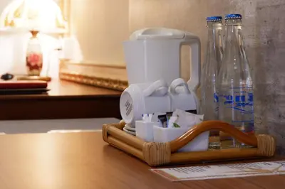 a coffee maker and bottles of water on a table at Seminyak Paradiso Hotel in Seminyak