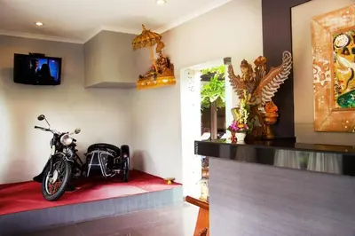 a motorcycle parked on a red rug in a room at Sindhu Mertha Suite in Sanur
