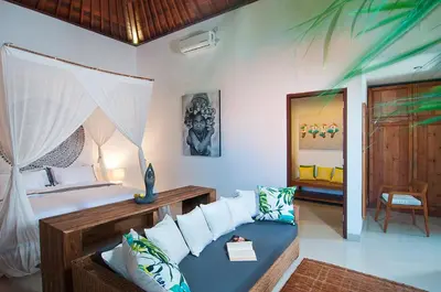 a bedroom with a bed and a couch in it at 3BR Villa Erja - Minggu Villas - Special Stay Bonus in Kerobokan