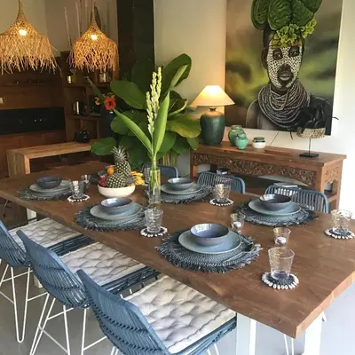 a dining room table with blue dishes on it at 3BR Villa Erja - Minggu Villas - Special Stay Bonus in Kerobokan