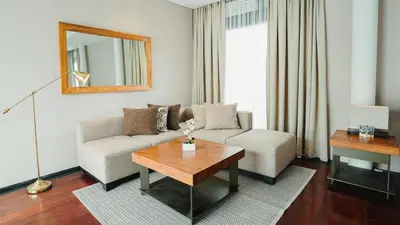 a living room with a couch and a table at Javana Royal Villas in Seminyak