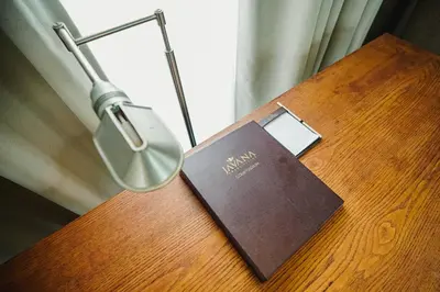 a book sitting on a table next to a lamp at Javana Royal Villas in Seminyak