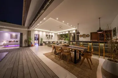 a living room with a table and a couch at Villa Tira - Elegant 3BR in Central Seminyak in Seminyak