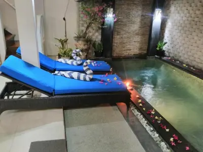 an indoor pool with a lazy river in a room at Sun Shoot Villas Seminyak in Seminyak