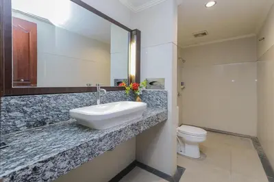 a bathroom with a sink and a toilet at Urbanview Hotel Taman Suci Denpasar Bali in Denpasar