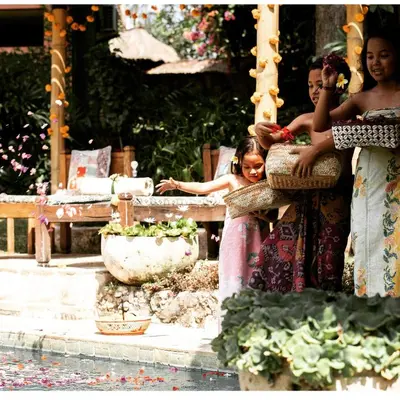 three women in dresses standing next to a fence at Villa Bella Bali - Authentic Balinese Luxury Villa with Tropical Elegance - Nanny and Cook in Canggu