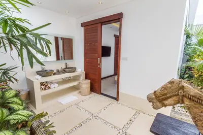 a bathroom with a mirror and a sink in a room at Villa Juna - Beautiful 3 Bedroom in Seminyak in Seminyak