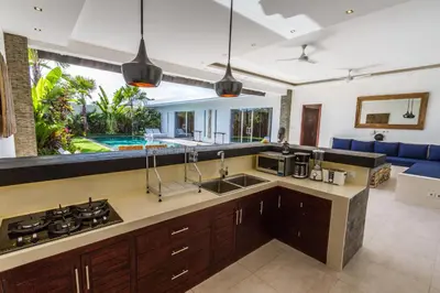 a kitchen with a sink and a stove at Villa Juna - Beautiful 3 Bedroom in Seminyak in Seminyak