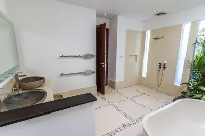 a bathroom with two sinks and a shower at Villa Nala - Amazing 3-Bedroom in Seminyak in Seminyak