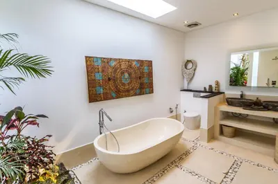 a bathroom with a bath tub and a sink at Villa Saha - Elegant 3-Bedroom in Seminyak in Seminyak