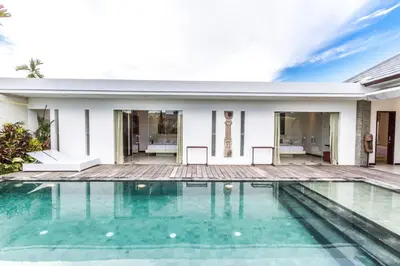 a swimming pool in front of a house at Villa Saha - Elegant 3-Bedroom in Seminyak in Seminyak