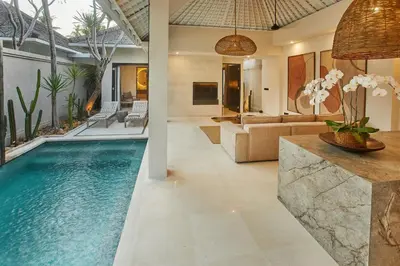 an infinity pool in the living room of a villa at Ahimsa Beach in Jimbaran