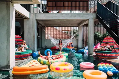 a group of people in an indoor water park at Cara Cara Inn in Kuta