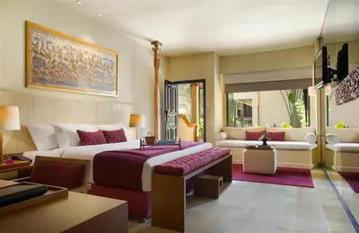 a bedroom with a large bed and a couch at Sadara Resort in Nusa Dua