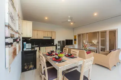 a kitchen and dining room with a table and chairs at Castro Villa in Seminyak