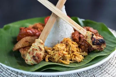 a plate of food with rice and chopsticks on it at Amarin Seminyak in Seminyak