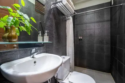 a bathroom with a white sink and a toilet at Pondok Sari Kuta in Kuta
