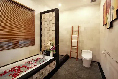 a bathroom with a tub and a toilet and a bath tub at De Liza Villa Seminyak Beachside By Bali Asia Villa in Seminyak