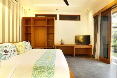 a bedroom with a bed and a television at Villa the Hotman Paris I Seminyak in Seminyak
