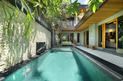 a swimming pool in the middle of a house at Villa the Hotman Paris I Seminyak in Seminyak