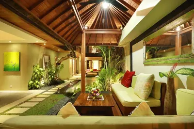 a living room with a couch and a table at Villa The Hotman Paris II Seminyak in Seminyak