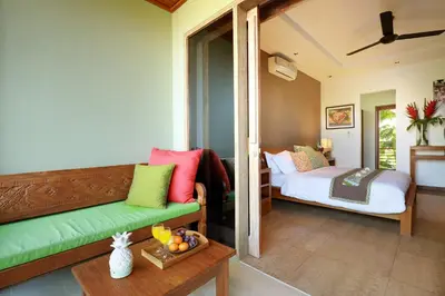 a living room with a couch and a bed at Villa The Hotman Paris II Seminyak in Seminyak