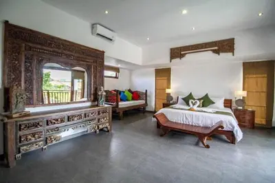 a large bedroom with a bed and a large mirror at Villa Khaleesi in Seminyak