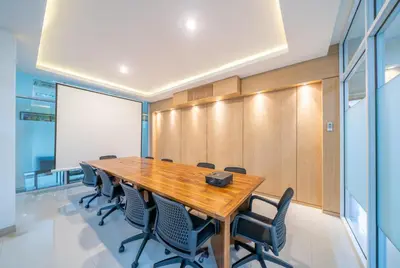 a conference room with a wooden table and chairs at Sara Residence by Nakula in Legian