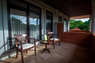 two chairs sitting in a room with large windows at Melasti Kuta Beach Hotel & Spa in Kuta