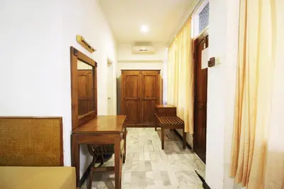 a hallway with a wooden desk and a door at Hotel Karthi Kuta in Kuta
