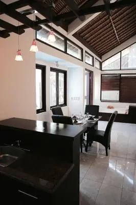 a kitchen and dining room with a table and chairs at The Lagoon Bali Pool Hotel and Suites in Legian