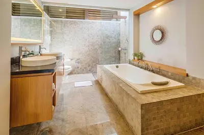 a bathroom with a tub and a sink and a toilet at Pradha Villas Seminyak in Seminyak