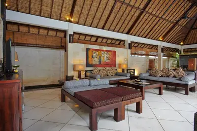 a living room with two couches and a tv at The Maya Seminyak Villas in Seminyak