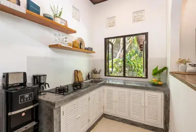 a kitchen with a sink and a stove at Twist and Shout Villa in Seminyak