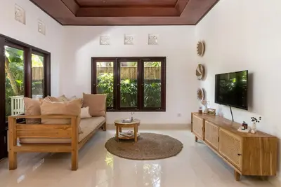 a living room with a couch and a tv at Twist and Shout Villa in Seminyak