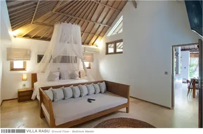 a bedroom with a bed and a couch in a room at 3BR Villa Rabu - Minggu Villas Seminyak in Seminyak