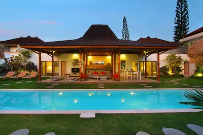 a house with a swimming pool in the yard at Villa Thiara by Optimum Bali Villas in Seminyak