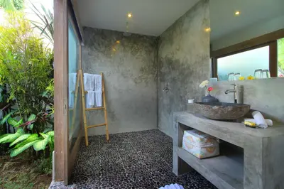 a bathroom with a sink and a mirror at Villa Thiara by Optimum Bali Villas in Seminyak