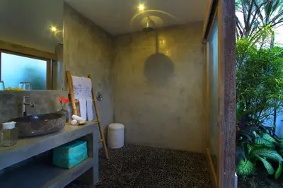 a bathroom with a sink and a mirror at Villa Thiara by Optimum Bali Villas in Seminyak