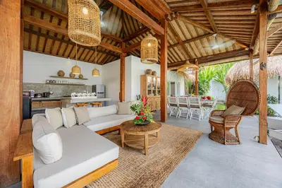 an open living room with a couch and a table at Renovated Villa Aksara Oberoi, 700m to Beach in Seminyak