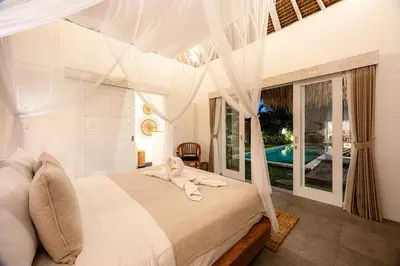 a bedroom with a bed with a canopy at Renovated Villa Aksara Oberoi, 700m to Beach in Seminyak