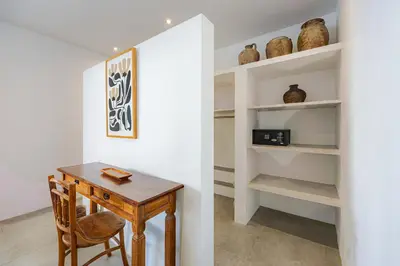 a dining room with a wooden table and shelves at Renovated Villa Aksara Oberoi, 700m to Beach in Seminyak